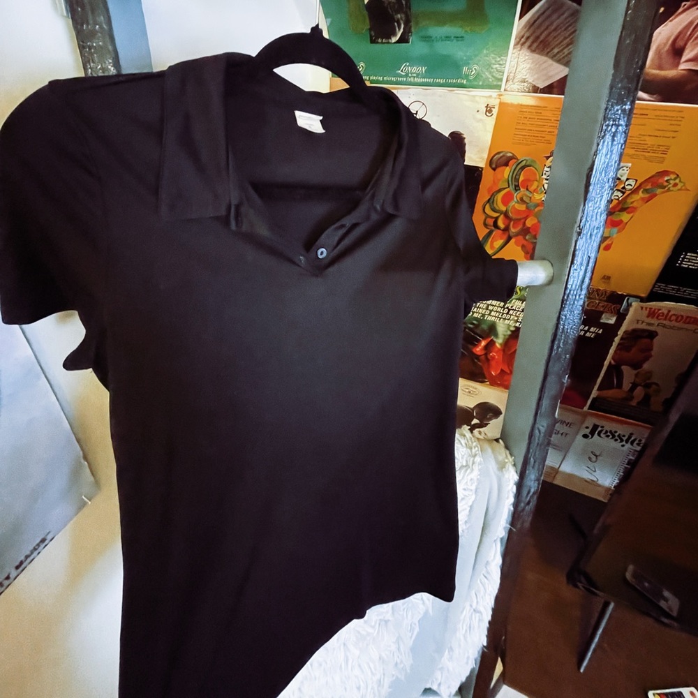 two womens dri fit black polos